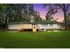Back exterior view of home with back deck, string lights and gorgeous sunset at 4705 Bernie Pl, Raleigh, NC 27616