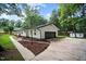 Charming home exterior with a dark garage door, beautiful stone and mulch landscaping at 4705 Bernie Pl, Raleigh, NC 27616