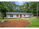 Charming single-story home featuring large windows, a manicured lawn, and a welcoming front entrance at 4705 Bernie Pl, Raleigh, NC 27616