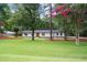 Stunning home exterior with a green lawn and mature trees, showcasing curb appeal at 4705 Bernie Pl, Raleigh, NC 27616