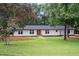 Charming single-story home with a well-manicured lawn and lush landscaping, offering great curb appeal at 4705 Bernie Pl, Raleigh, NC 27616