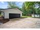 Close up of exterior of house showing a garage door and nice rock and mulch landscaping at 4705 Bernie Pl, Raleigh, NC 27616