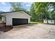 Exterior angle of home displaying attached garage, long driveway, and landscaping at 4705 Bernie Pl, Raleigh, NC 27616