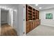 Spacious office features built-in wood shelving and drawers, paired with neutral carpet and paint at 4705 Bernie Pl, Raleigh, NC 27616