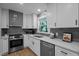 Well-lit kitchen with new appliances and grey backsplash at 4705 Bernie Pl, Raleigh, NC 27616