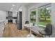 Well-lit kitchen and nook with stainless steel appliances, white cabinetry, and a view to the exterior at 4705 Bernie Pl, Raleigh, NC 27616