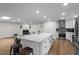 Spacious kitchen with a central island, stainless steel appliances, and an adjacent fireplace at 4705 Bernie Pl, Raleigh, NC 27616