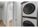Convenient laundry area features a stacked washer and dryer with modern finishes at 4705 Bernie Pl, Raleigh, NC 27616