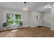 Bright open room with large window and new wood flooring at 4705 Bernie Pl, Raleigh, NC 27616