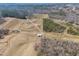 Expansive aerial view showcasing farmland with distant trees, roads and structures at 492 Arlie Ln, Lillington, NC 27546