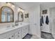 Bright bathroom with double vanity, wood framed mirrors, and glass enclosed shower at 492 Arlie Ln, Lillington, NC 27546