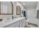 Bright bathroom with double vanity, framed mirrors, and shower/tub combo at 492 Arlie Ln, Lillington, NC 27546