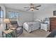 Bedroom with accent chair, ceiling fan, side table, and neutral walls at 492 Arlie Ln, Lillington, NC 27546