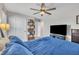 Bedroom with a comfy blue comforter, ceiling fan, and closet at 492 Arlie Ln, Lillington, NC 27546