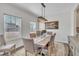 Bright dining room features a wooden table with upholstered chairs and a modern light fixture at 492 Arlie Ln, Lillington, NC 27546