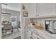 Bright dining room with a view into the kitchen featuring light countertops and white cabinets at 492 Arlie Ln, Lillington, NC 27546