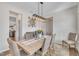 Well-lit dining area with a wooden table, upholstered chairs, and stylish decor at 492 Arlie Ln, Lillington, NC 27546
