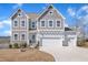 Charming two-story home with a three-car garage, stone accents, and a well-manicured lawn at 492 Arlie Ln, Lillington, NC 27546