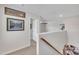 Upstairs hallway with neutral colored walls and carpeted floors, and beautiful mountain pictures at 492 Arlie Ln, Lillington, NC 27546