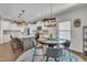 Bright kitchen features white cabinets, marble countertops, pendant lighting, and round breakfast table at 492 Arlie Ln, Lillington, NC 27546