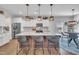 Spacious kitchen with an island, pendant lighting, stainless steel appliances, and a view into the dining area at 492 Arlie Ln, Lillington, NC 27546