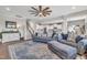 Cozy living room with a large sofa, wood floors, a staircase, and an open view to the kitchen at 492 Arlie Ln, Lillington, NC 27546