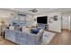 Comfortable living room features plush seating, a ceiling fan, a TV, and natural light from the window at 492 Arlie Ln, Lillington, NC 27546