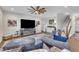 Spacious living room with dark wood floors, large television, wood fan, and comfortable blue sofa at 492 Arlie Ln, Lillington, NC 27546