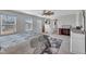 Bright main bedroom with a large bed, ceiling fan, lots of natural light and soft neutral carpet at 492 Arlie Ln, Lillington, NC 27546