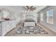 Main bedroom with a ceiling fan, a neutral rug, dresser, and a comfortable bed with white furniture at 492 Arlie Ln, Lillington, NC 27546