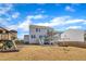 Rear exterior view with deck, patio, fenced yard, and playground at 492 Arlie Ln, Lillington, NC 27546