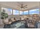 Screened in sunroom with natural lighting, ceiling fan and comfortable furniture at 492 Arlie Ln, Lillington, NC 27546