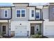 Charming townhome featuring neutral siding, attached garage, and inviting front entrance at 5004 Cambrey Dr # 3, Durham, NC 27703