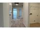 Hallway with neutral carpet leading to bedrooms and a laundry room at 5004 Cambrey Dr # 3, Durham, NC 27703