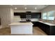 Modern kitchen with dark cabinets, stainless steel appliances, and center island with white countertop at 5004 Cambrey Dr # 3, Durham, NC 27703