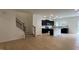 Open-concept living space with wood floors that flows into the kitchen and staircase to the second floor at 5004 Cambrey Dr # 3, Durham, NC 27703