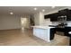 Open-concept living space with wood floors flowing into the kitchen and staircase to the second floor at 5004 Cambrey Dr # 3, Durham, NC 27703