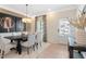 Bright dining room with modern chandelier, stylish drapes, and decorative wall art at 53 Mildred Pl, Broadway, NC 27505
