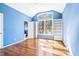 Large bedroom with vaulted ceilings, large windows, bright blue walls and built-in shelving at 563 Oak Crest Drive Dr, Chapel Hill, NC 27516