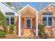 Close-up of a brick home's entrance featuring columns and sidelights at 563 Oak Crest Drive Dr, Chapel Hill, NC 27516