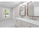Bright bathroom featuring double sinks, marble countertops, and modern finishes at 567 Howard Tant Rd, Zebulon, NC 27597