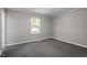 Cozy bedroom featuring carpeted floors, a window for natural light, and neutral walls at 567 Howard Tant Rd, Zebulon, NC 27597