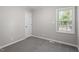 Neutral bedroom with carpet, a window offering natural light, and a closet for storage at 567 Howard Tant Rd, Zebulon, NC 27597