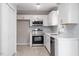 Remodeled kitchen with white cabinets, stainless appliances and new light colored wood floors at 567 Howard Tant Rd, Zebulon, NC 27597