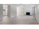 Open-concept living room featuring a fireplace, hardwood floors, and views into the modern kitchen at 567 Howard Tant Rd, Zebulon, NC 27597