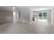 Bright living room with hardwood floors leading to sliding glass doors and an adjacent kitchen at 567 Howard Tant Rd, Zebulon, NC 27597