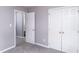 This bedroom has carpeting and double closets, with a door to the bathroom at 5748 Presentation St, Knightdale, NC 27545