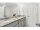 Bright bathroom featuring a double vanity, granite countertops, and modern fixtures at 5902 Carmel Ln, Raleigh, NC 27609