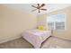 Bright bedroom featuring neutral walls, ceiling fan, and a window with natural light at 5923 Cameo Glass Way, Raleigh, NC 27612