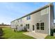 An exterior rear view of the new home boasts a grass backyard with a patio at 602 Andrade Dr, Fuquay Varina, NC 27526